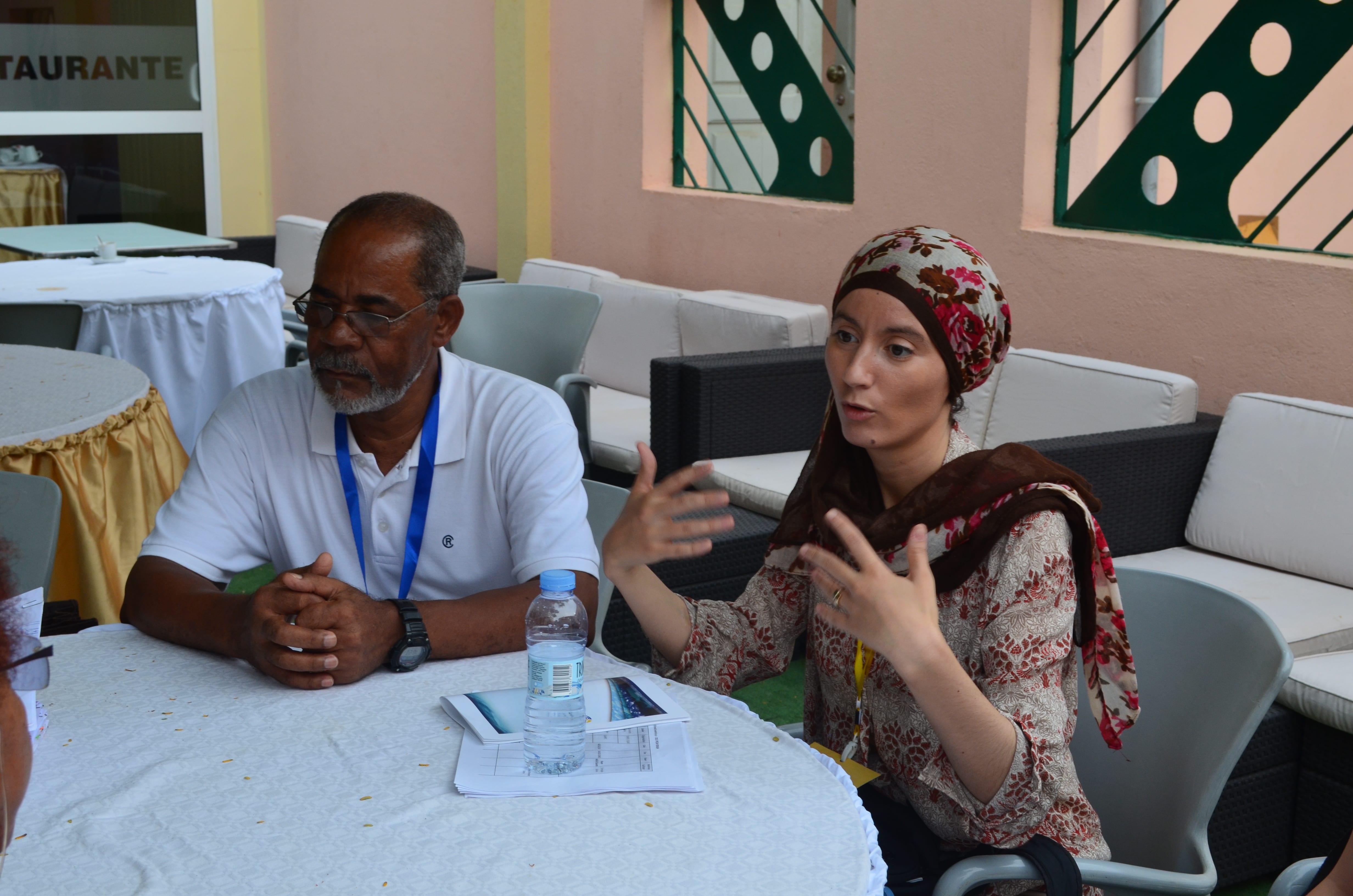 Dyhia passionately explaining the work of the Sea Around Us and our involvement in West Africa, alongside another delegate at the PRCM.