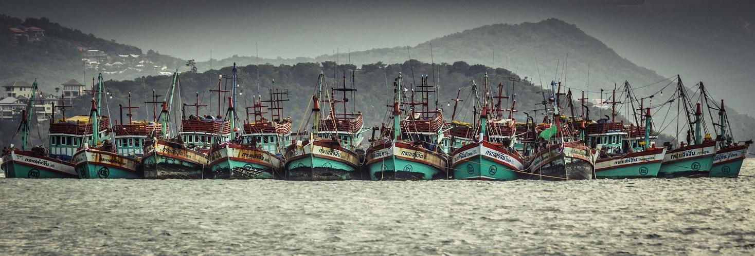 Fishing boats huddling together waiting for a storm to pass. Koh Samui Island,Thailand. Photo by Chris Bird, Flickr.