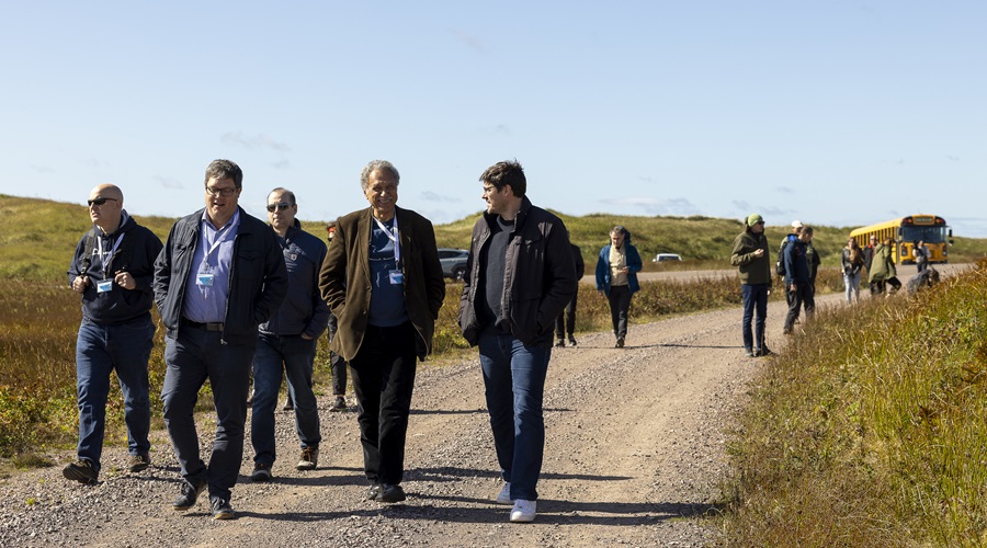 Daniel Pauly, Fabrice Teletchea and congress participants walking on a dirt road in Miquelon.