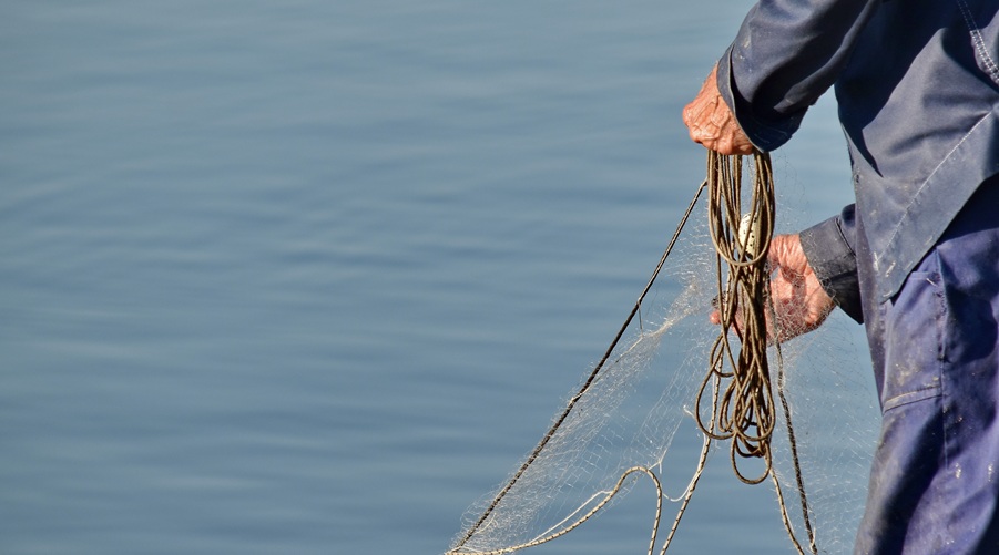 Male hands holding fishing nets